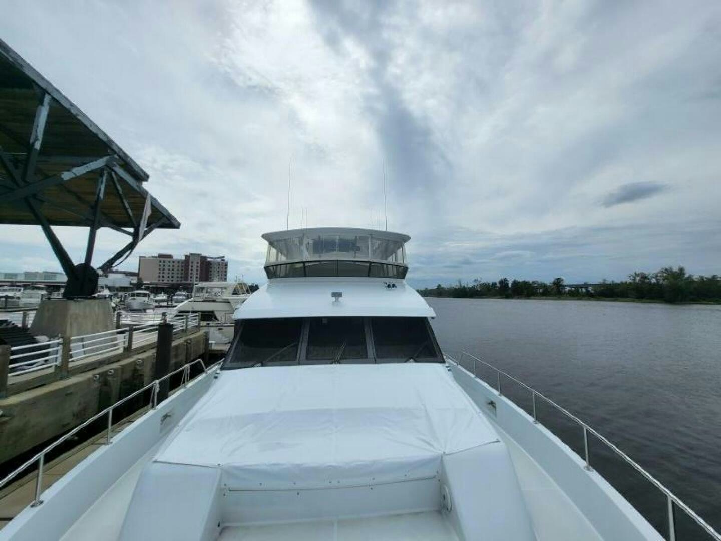a large white boat in a harbor aboard MAR JON Yacht for Sale