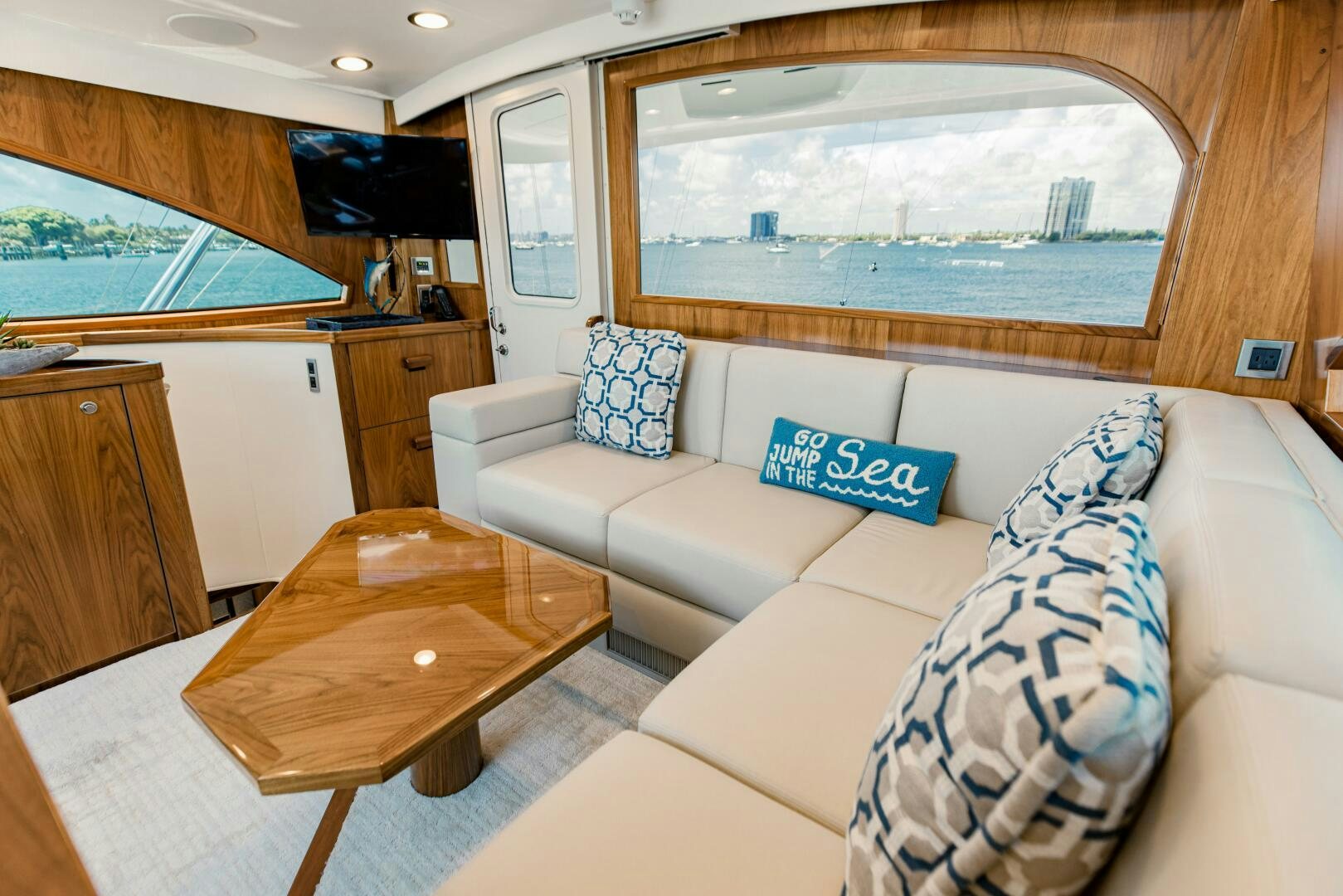 a living room with a large window aboard DOUBLE SHOT Yacht for Sale