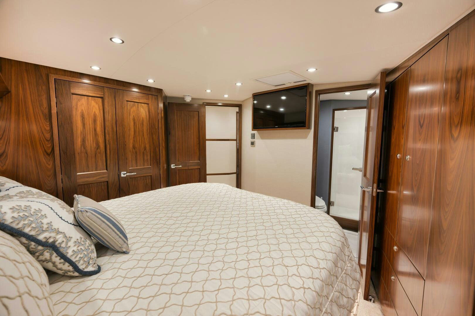 a bedroom with a bed and a television aboard DOUBLE SHOT Yacht for Sale