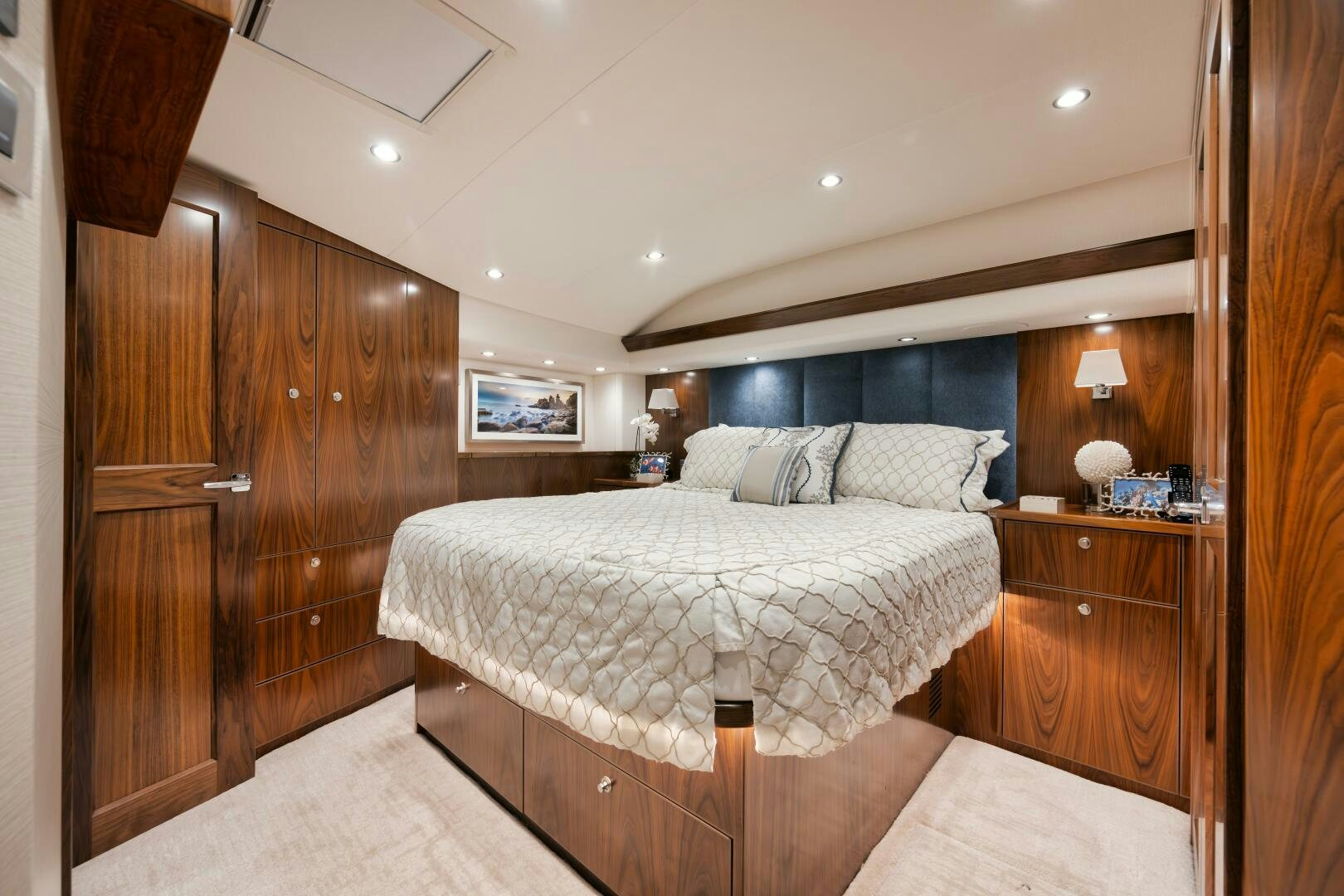 a bedroom with a bed and a wood cabinet aboard DOUBLE SHOT Yacht for Sale
