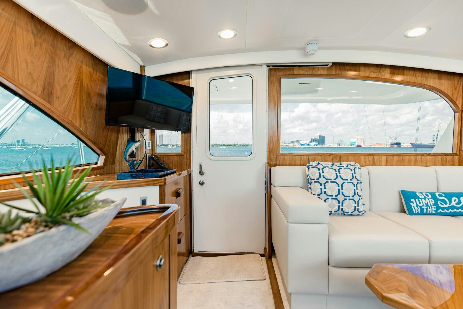 a living room with a large window aboard DOUBLE SHOT Yacht for Sale