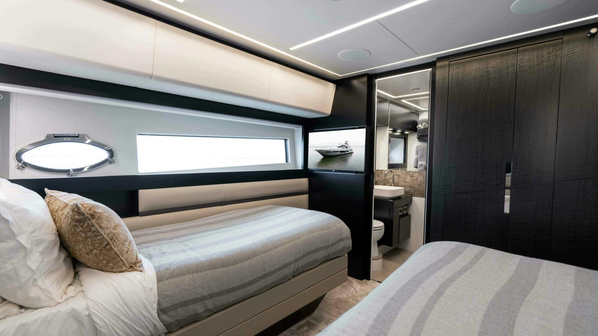 a room with a bed and a mirror aboard STALLION Yacht for Sale