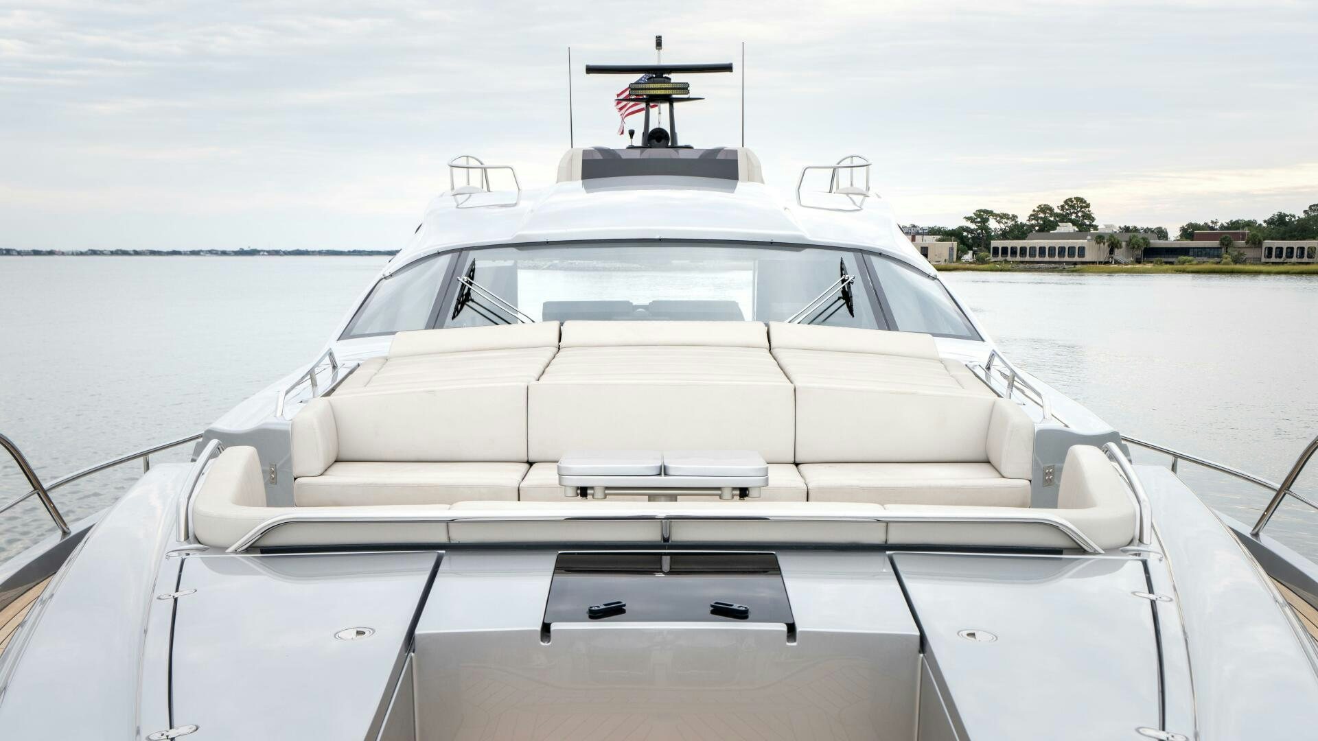 a white boat on a body of water aboard STALLION Yacht for Sale