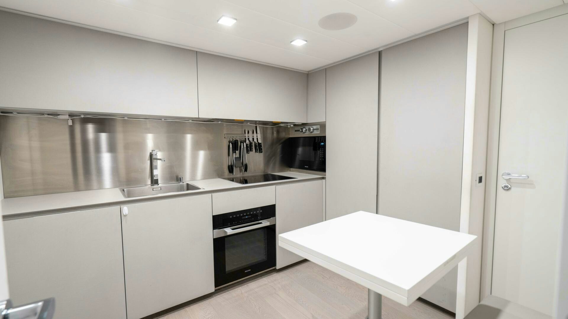 a kitchen with white cabinets aboard STALLION Yacht for Sale