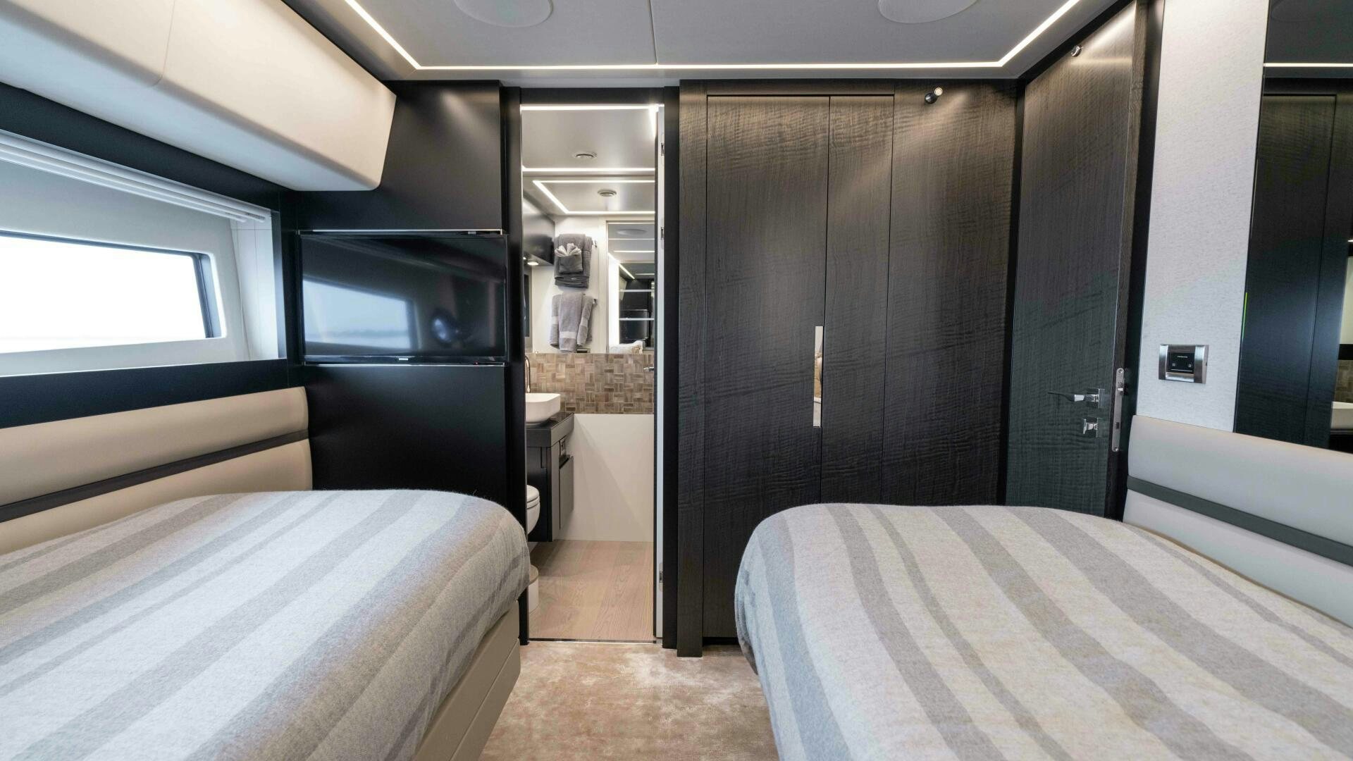 a room with a bed and a closet aboard STALLION Yacht for Sale