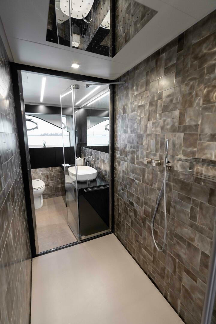 a bathroom with a glass shower aboard STALLION Yacht for Sale