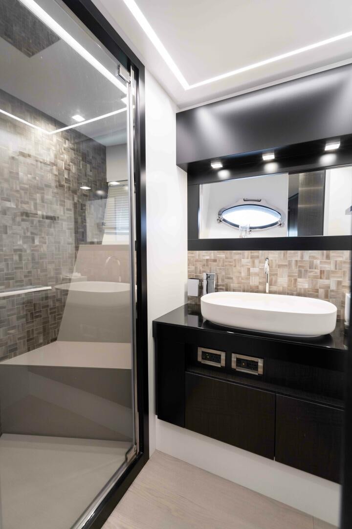 a bathroom with a large mirror aboard STALLION Yacht for Sale