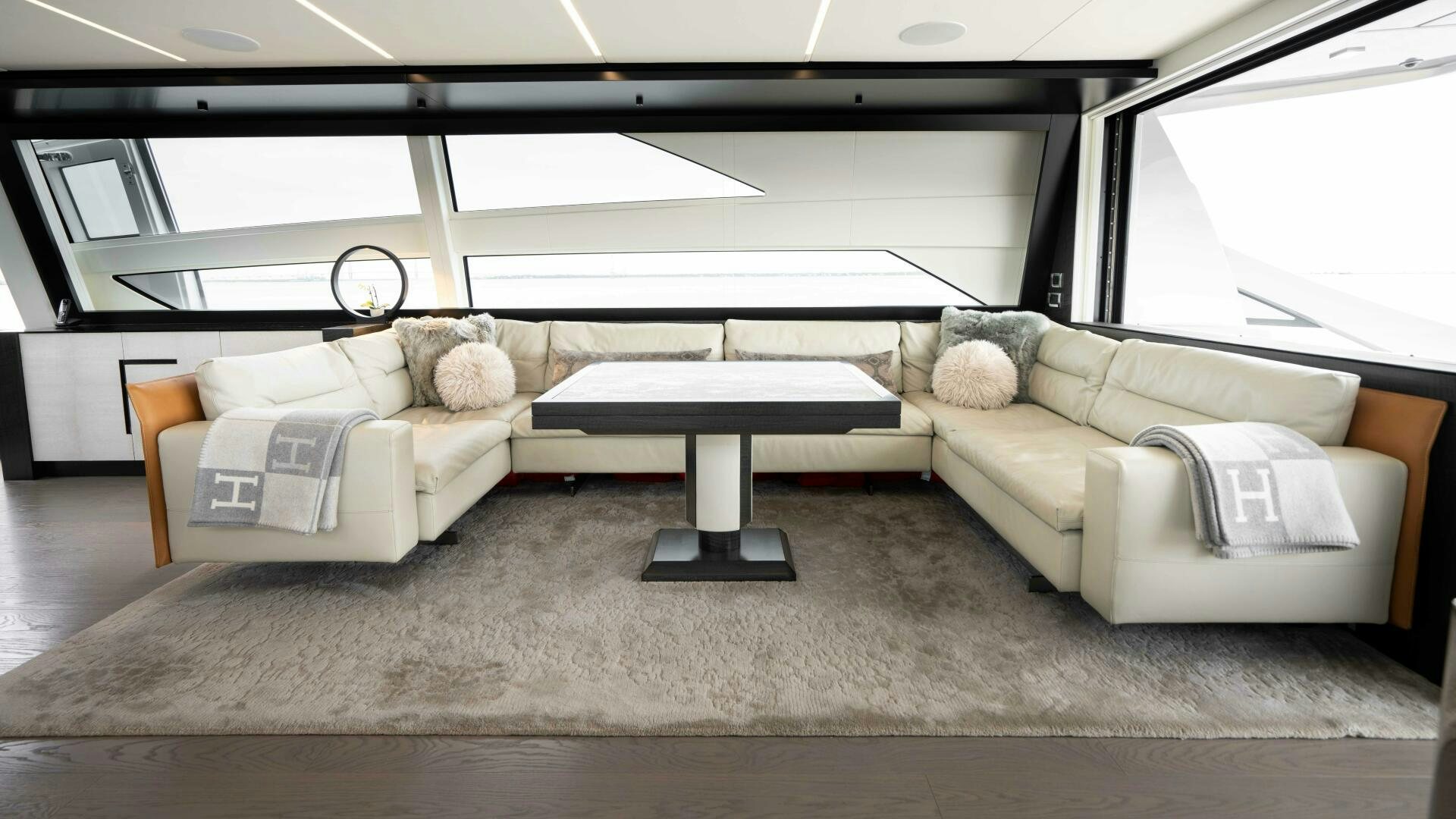 a living room with a couch and a coffee table aboard STALLION Yacht for Sale