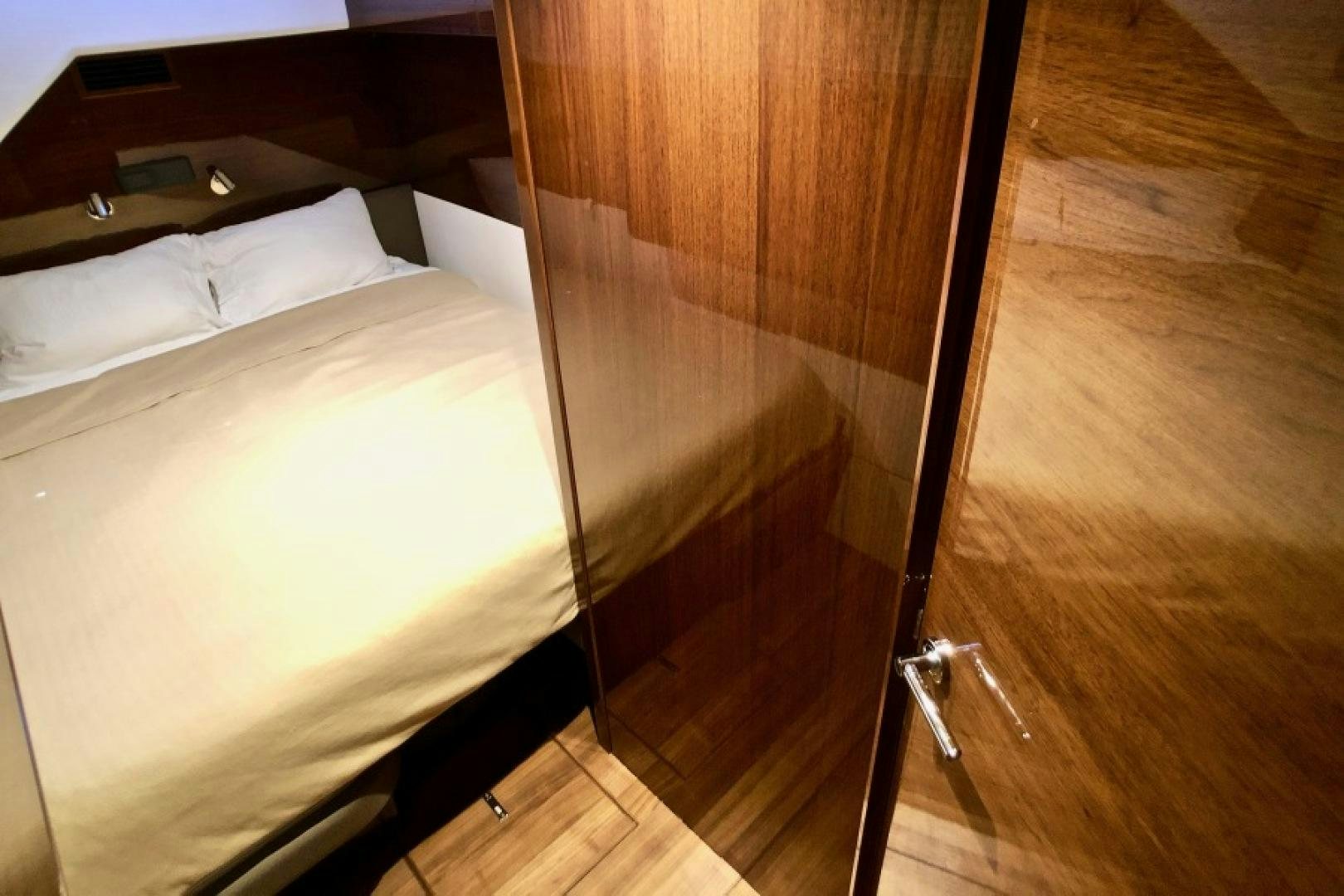 a bed with a wooden headboard aboard THE O SHEAUX Yacht for Sale