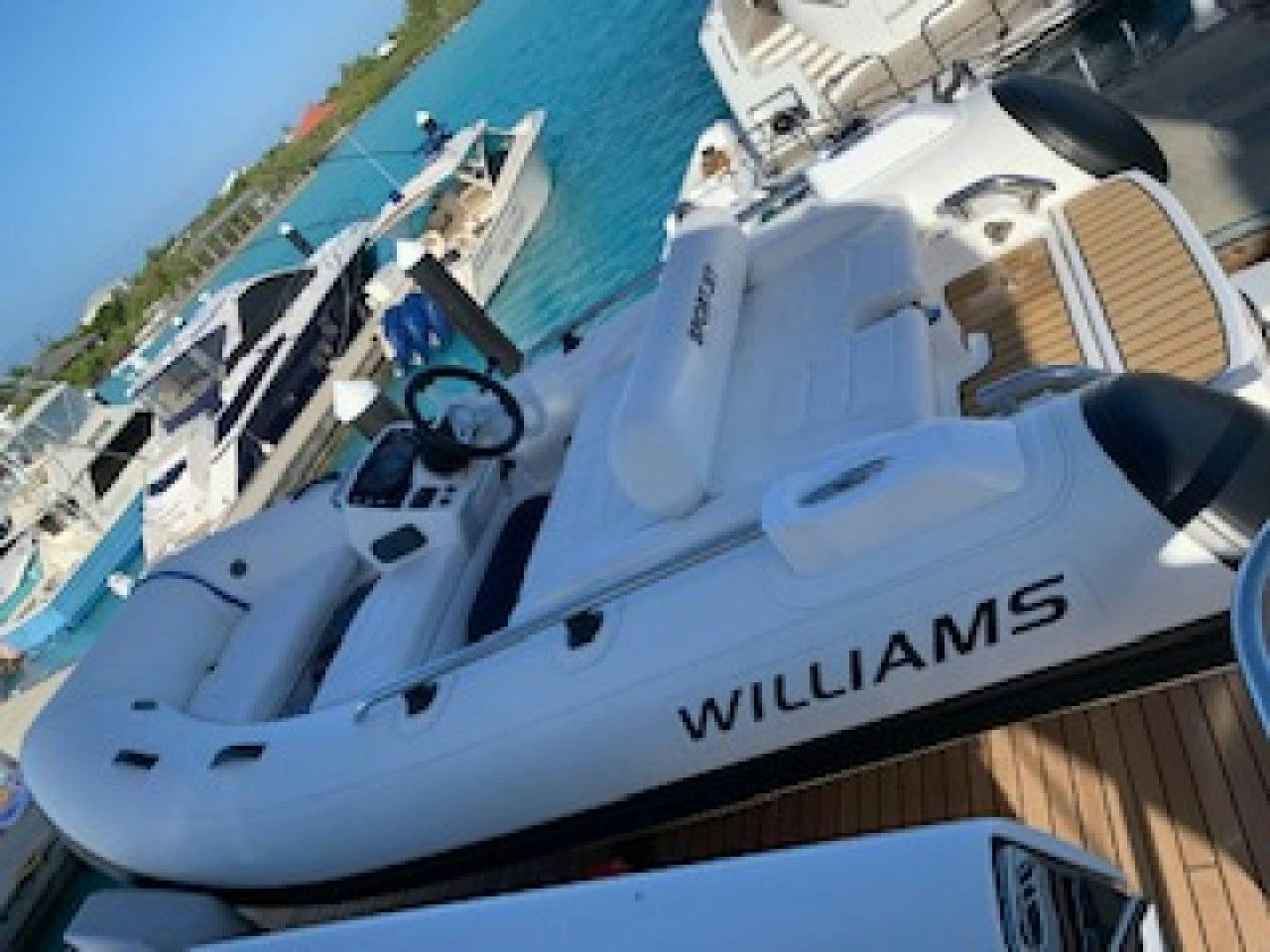 a white boat with black text aboard THE O SHEAUX Yacht for Sale