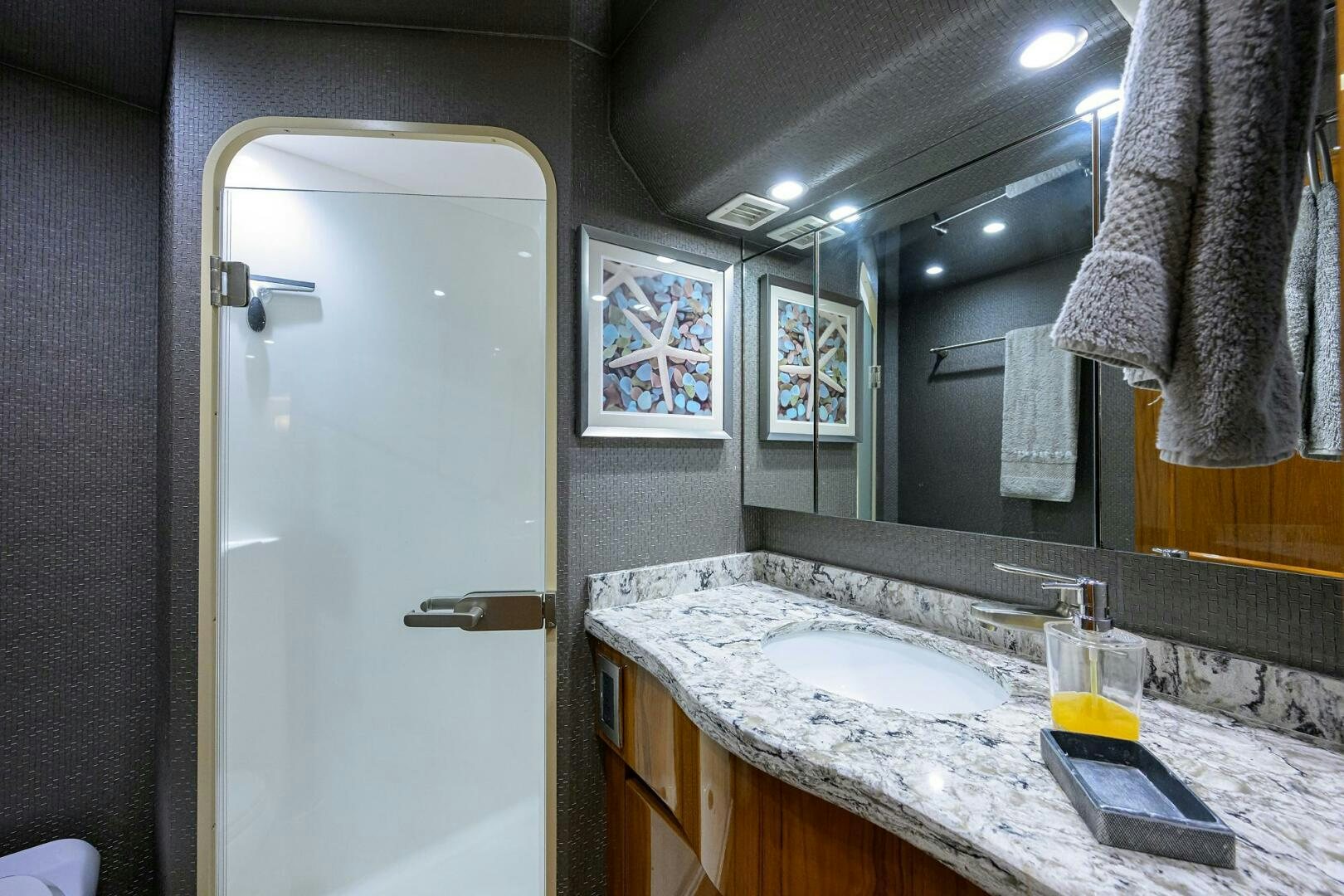 a bathroom with a countertop sink and mirror aboard TORTA Yacht for Sale