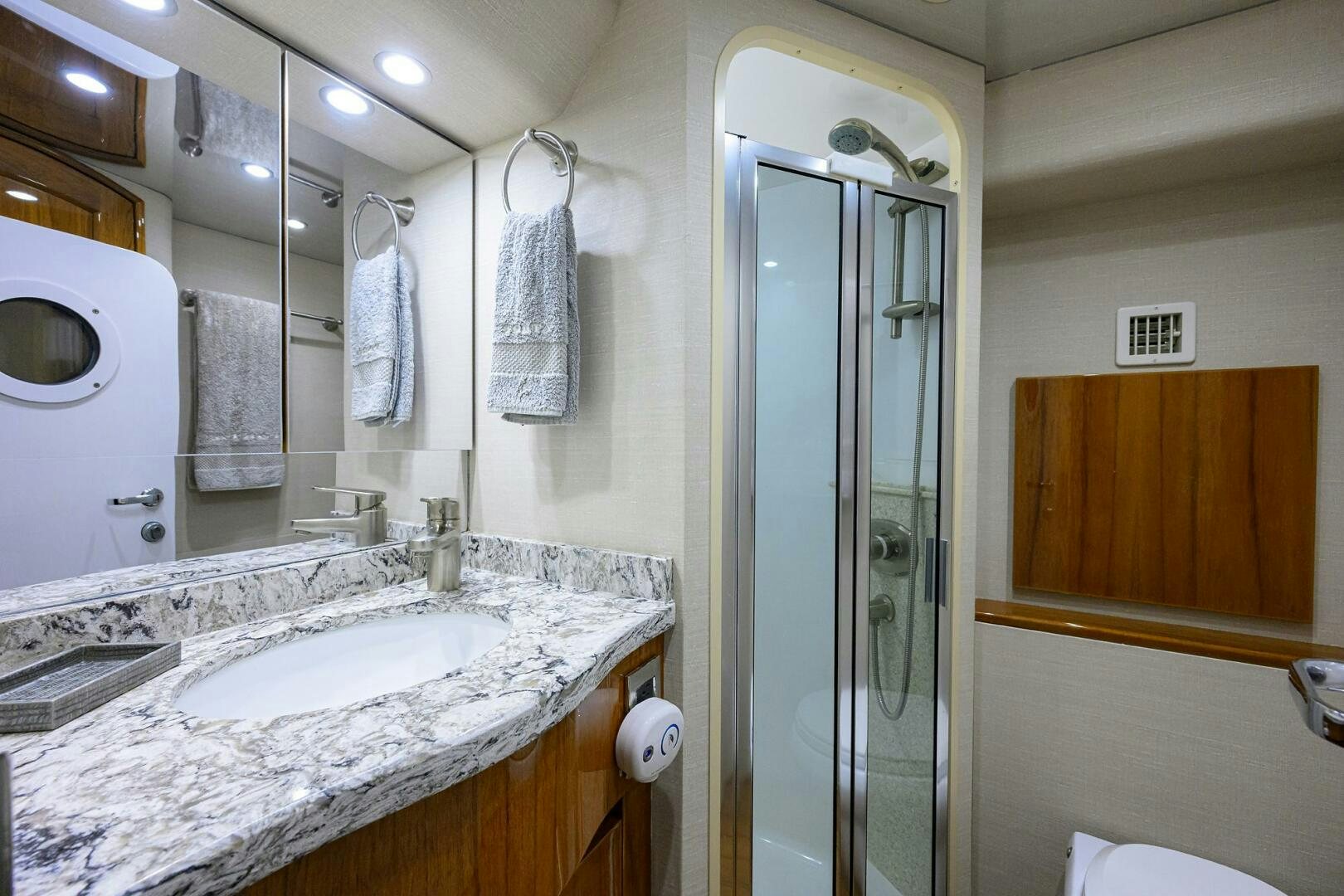 a bathroom with a glass shower door aboard TORTA Yacht for Sale