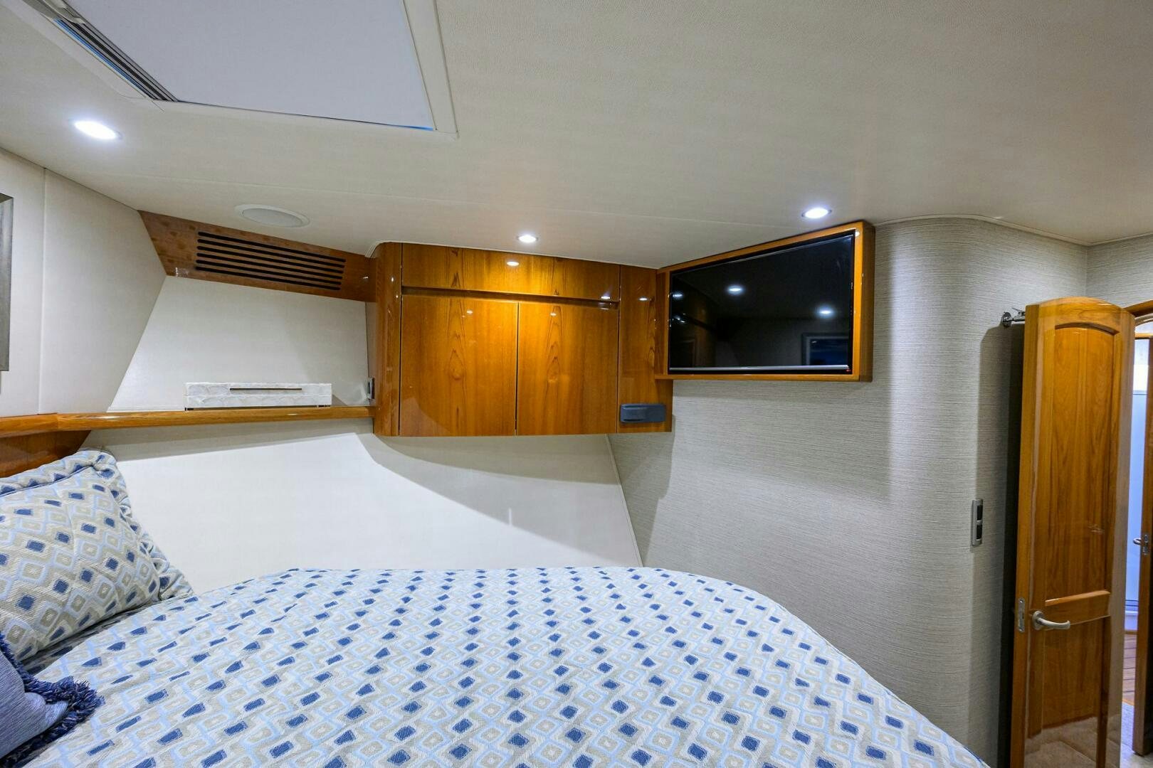 a bedroom with a bed and a television aboard TORTA Yacht for Sale
