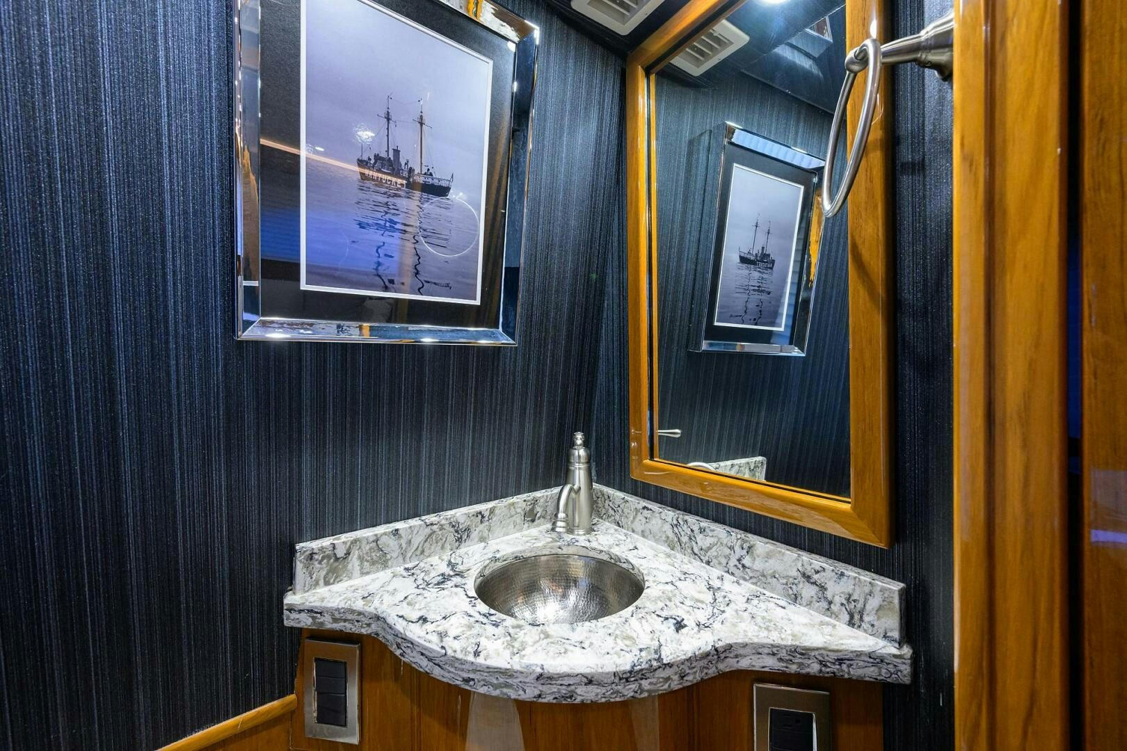 a bathroom with a sink and mirror aboard TORTA Yacht for Sale