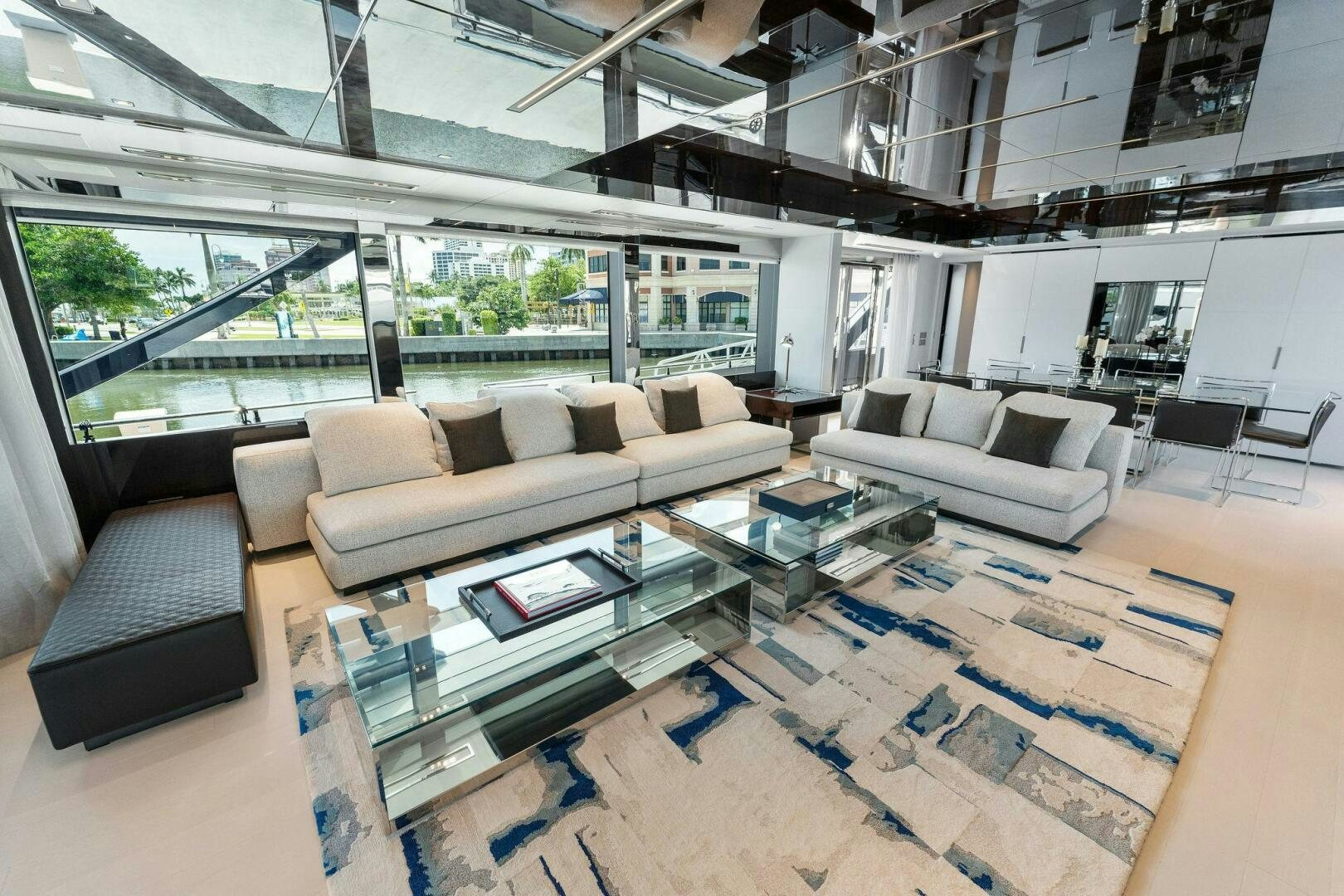 a living room with a large window aboard 110' RIVA DOLCEVITA 2024 Yacht for Sale