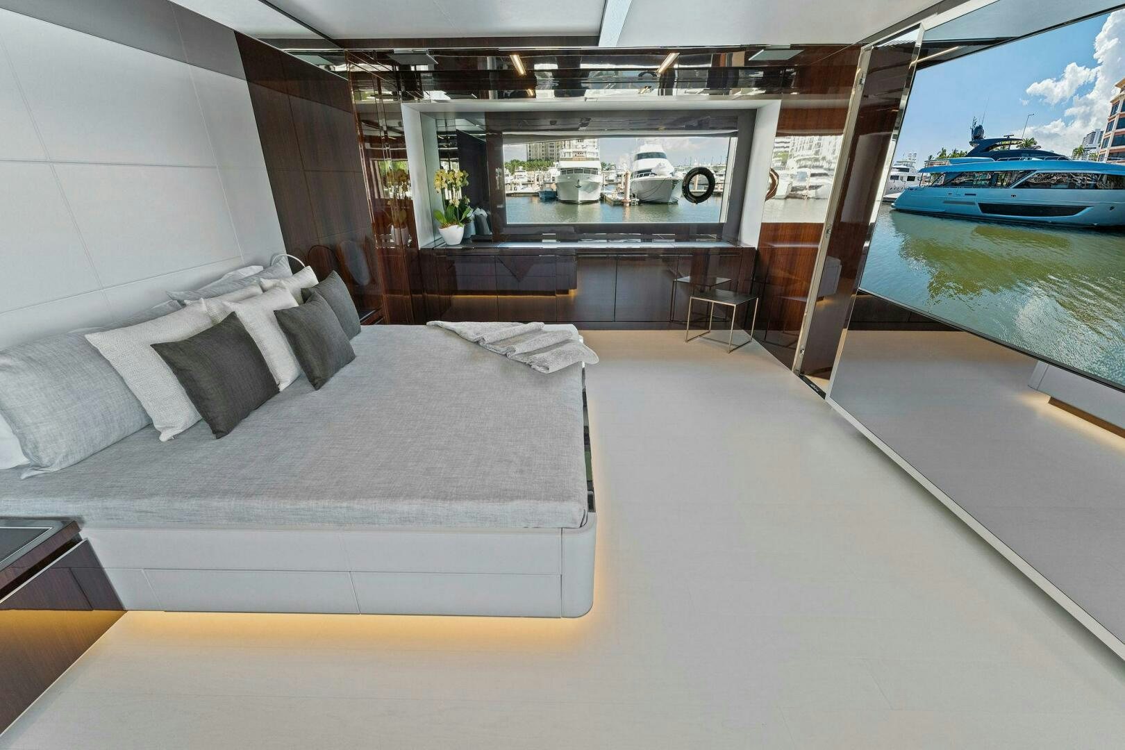 a room with a bed and a large window aboard 110' RIVA DOLCEVITA 2024 Yacht for Sale