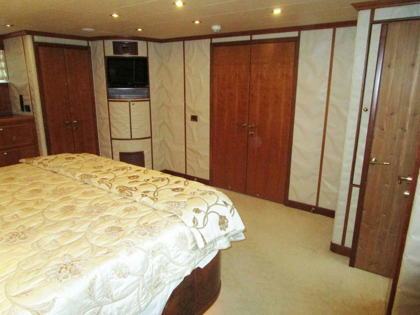 a bedroom with a bed and a television aboard LADY D Yacht for Sale