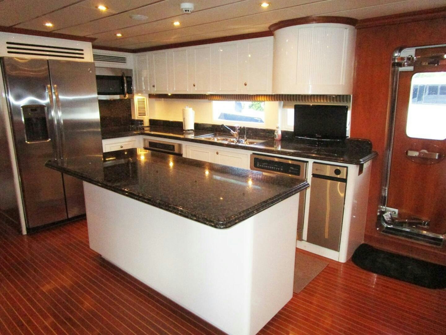 a kitchen with a refrigerator and a microwave aboard LADY D Yacht for Sale
