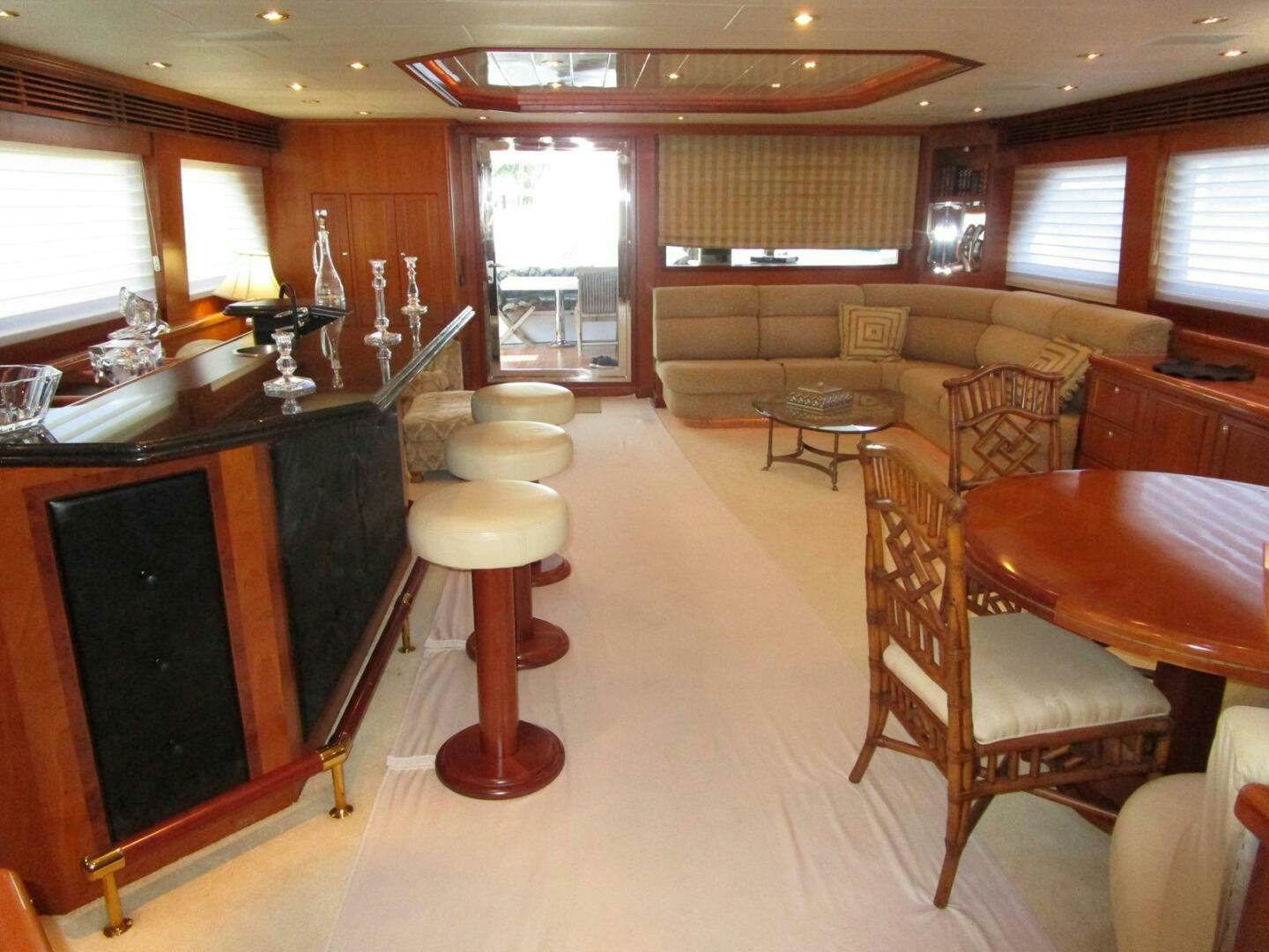 a room with a bar and chairs aboard LADY D Yacht for Sale