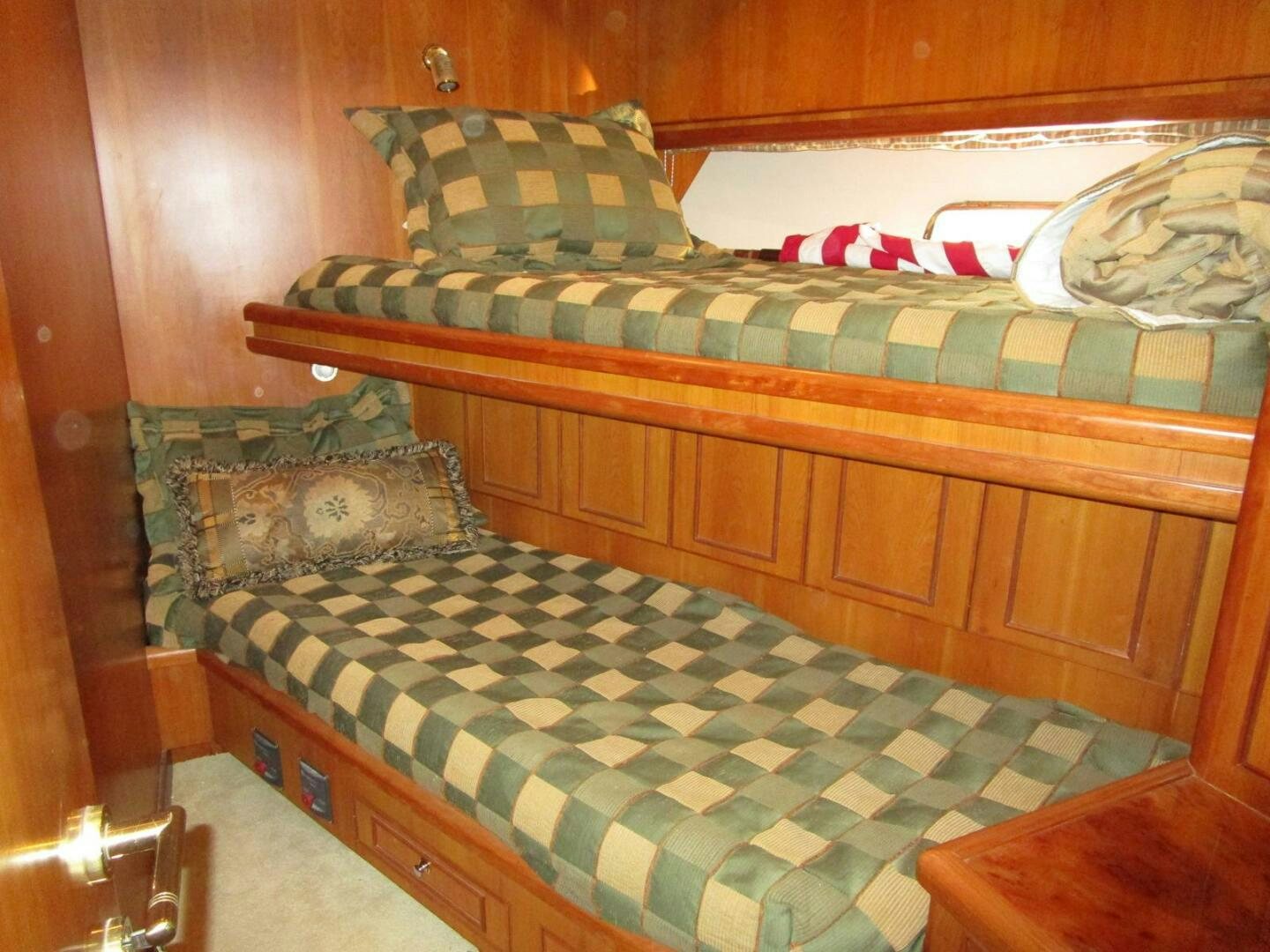 a bed with a plaid sheet aboard LADY D Yacht for Sale