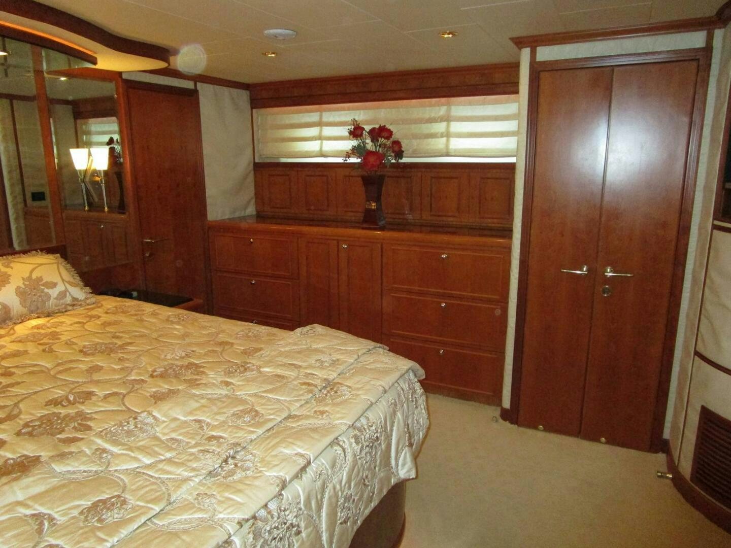 a bedroom with a bed and a wood door aboard LADY D Yacht for Sale