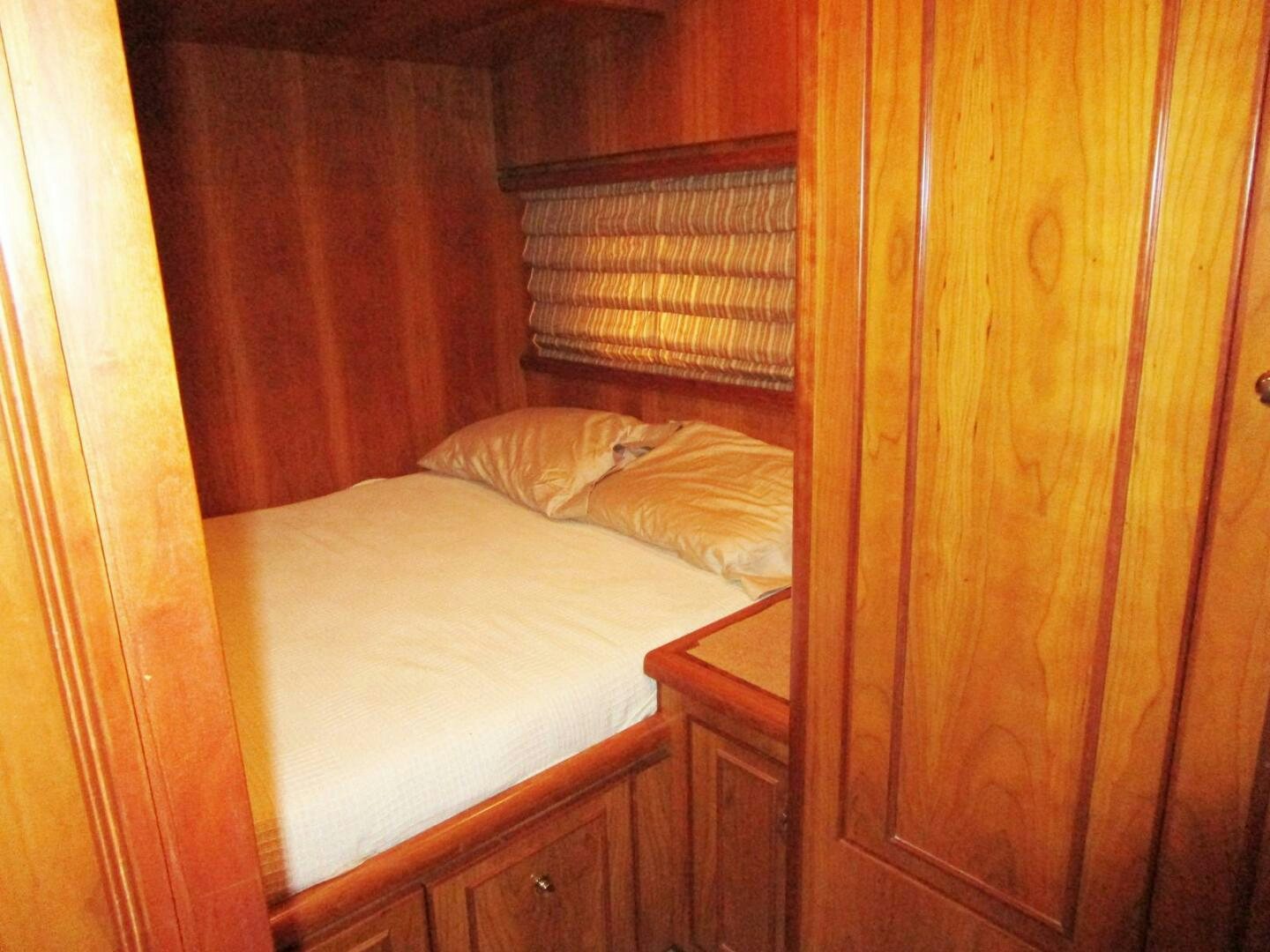 a bed with a wooden headboard aboard LADY D Yacht for Sale