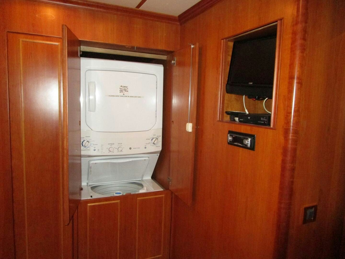 a microwave oven on a wooden cabinet aboard LADY D Yacht for Sale