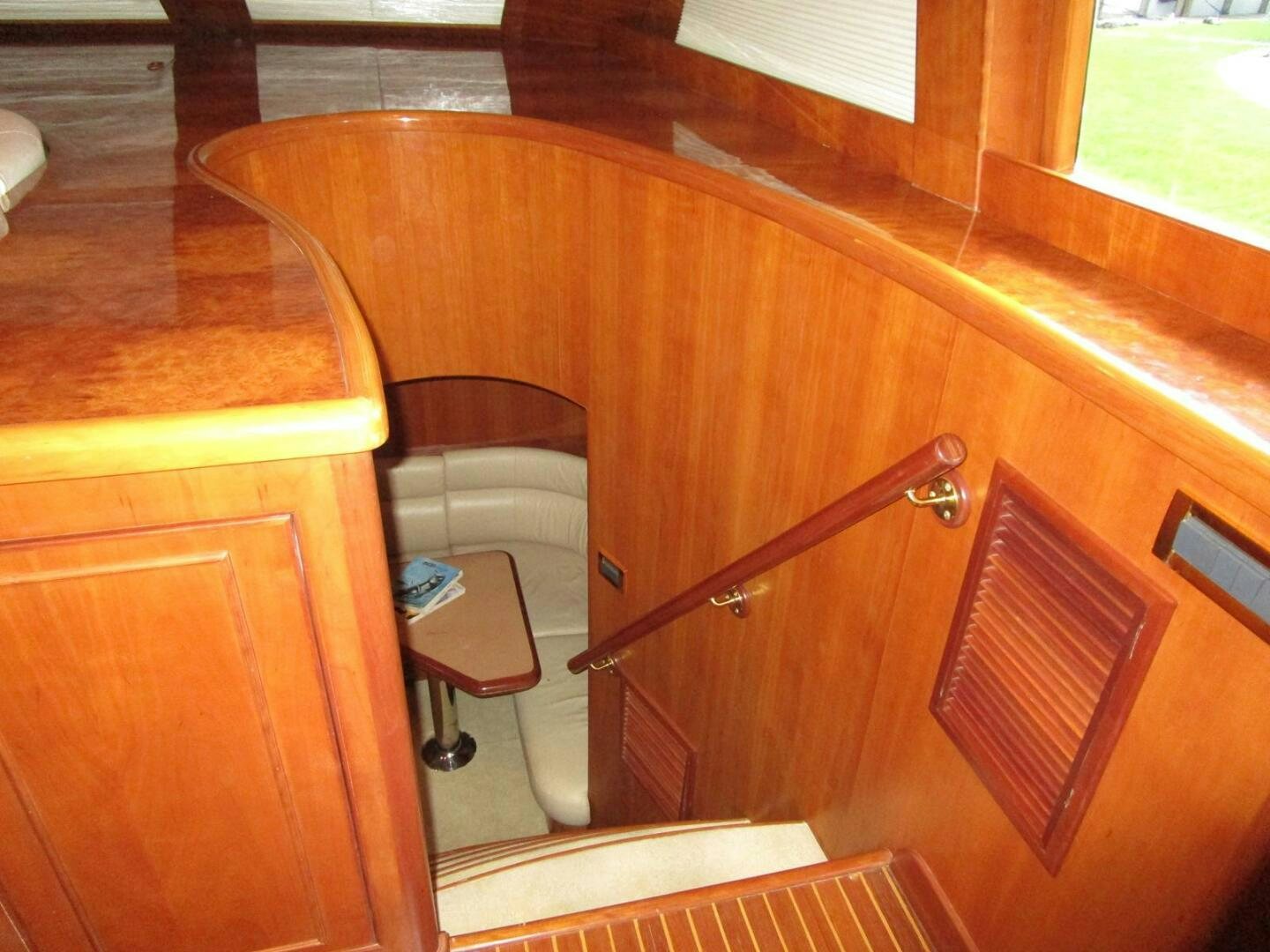 a wooden cabinet with a stool aboard LADY D Yacht for Sale