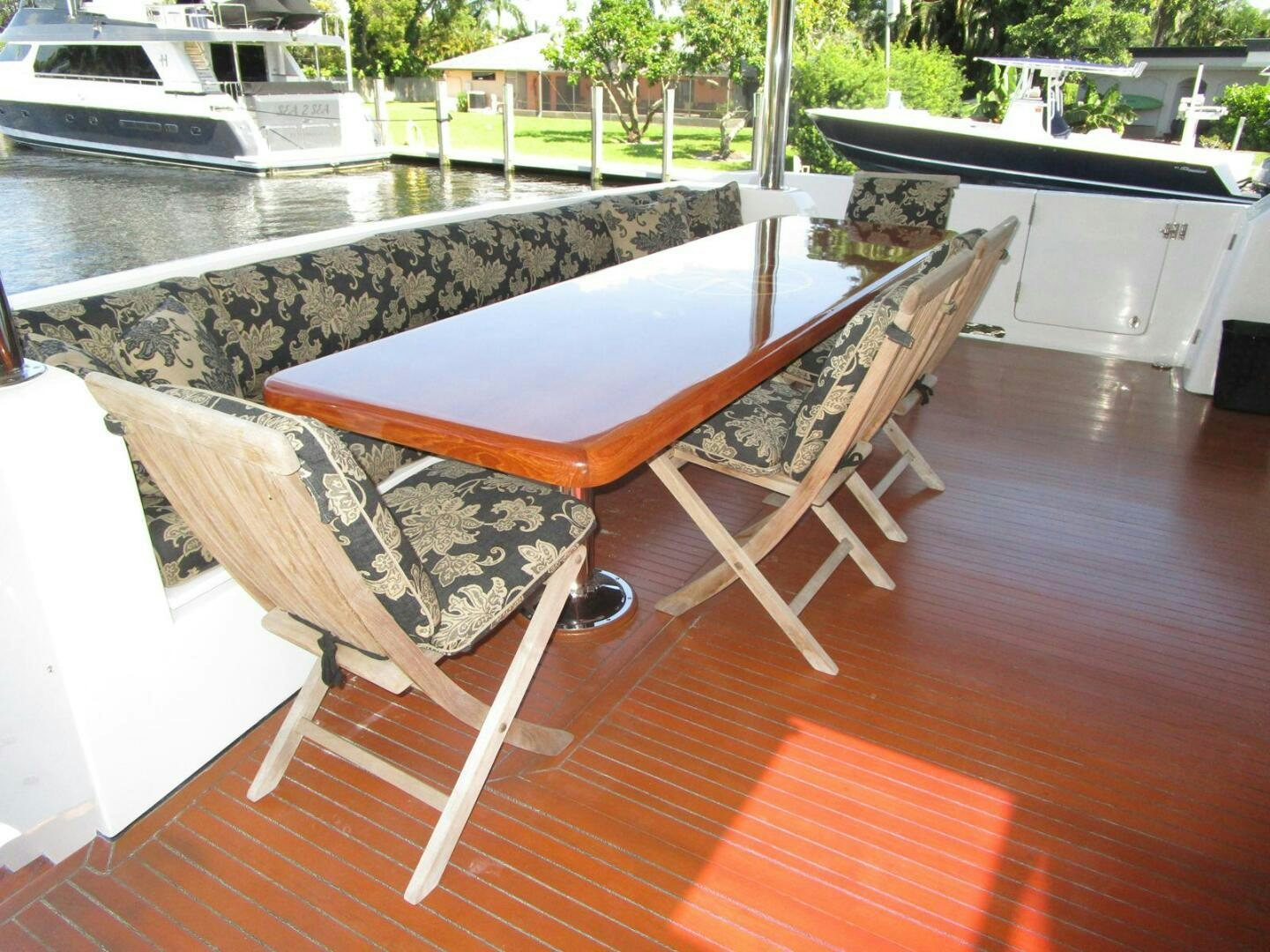 a table and chairs on a deck aboard LADY D Yacht for Sale