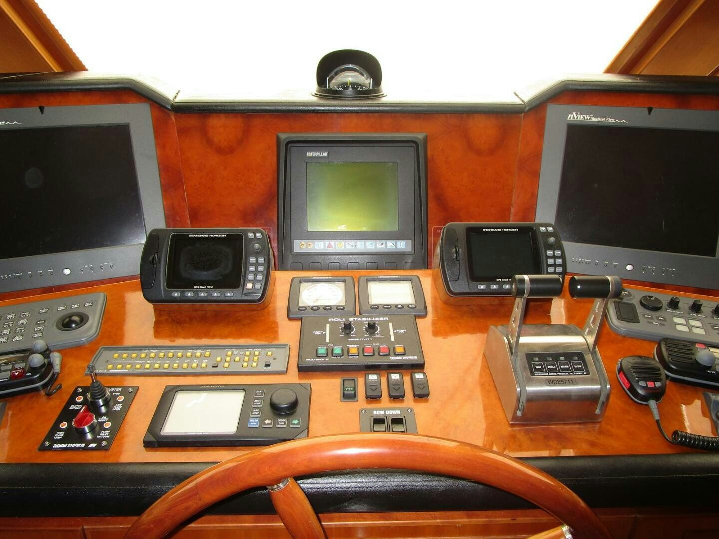 a wooden table with electronic devices aboard LADY D Yacht for Sale