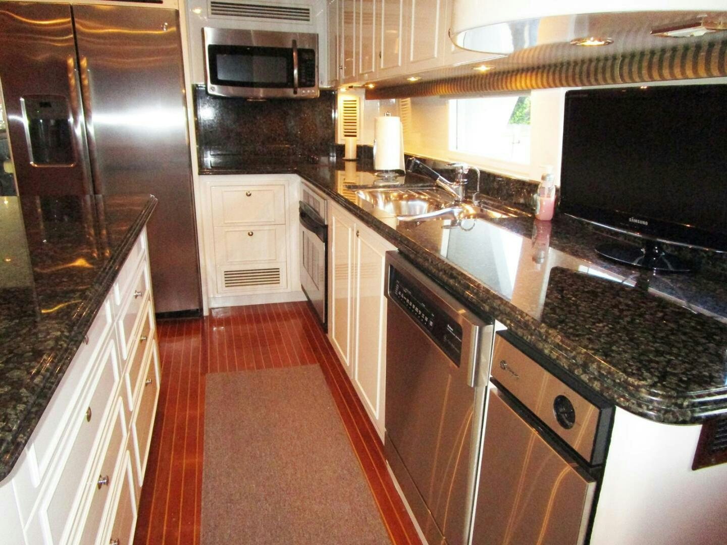 a kitchen with black appliances aboard LADY D Yacht for Sale
