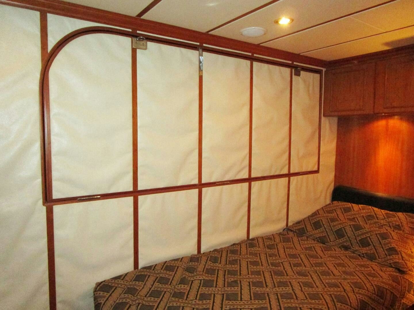 a bed with a red and white striped sheet aboard LADY D Yacht for Sale