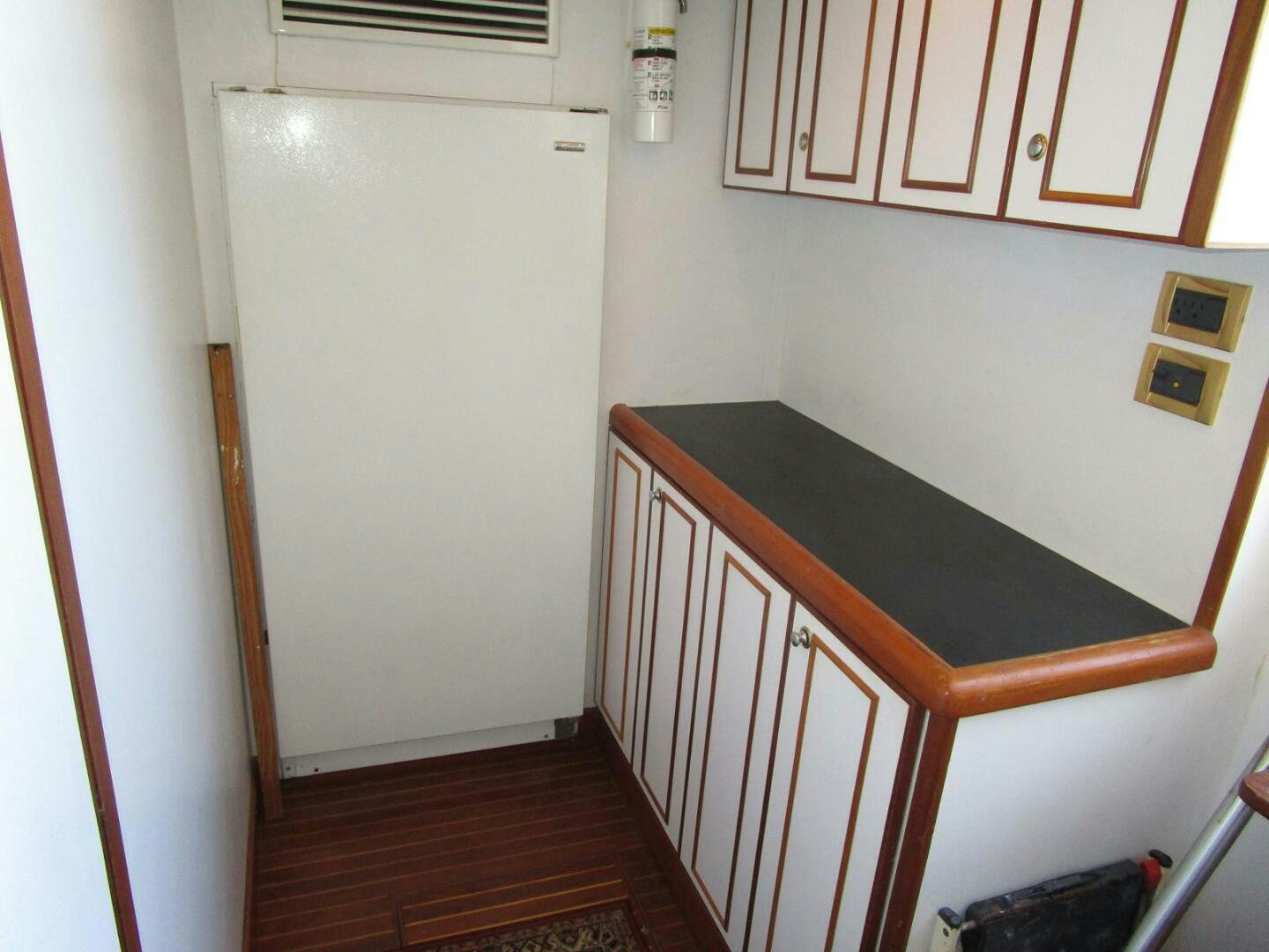 a kitchen with a white refrigerator aboard LADY D Yacht for Sale