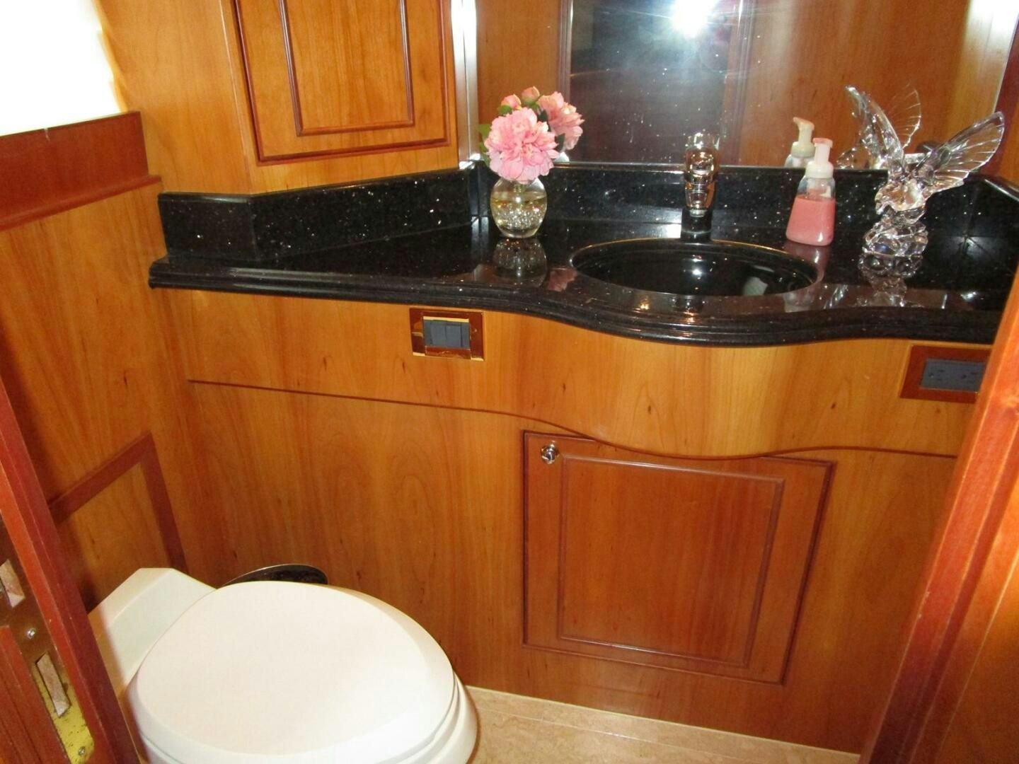 a bathroom sink with a mirror above it aboard LADY D Yacht for Sale