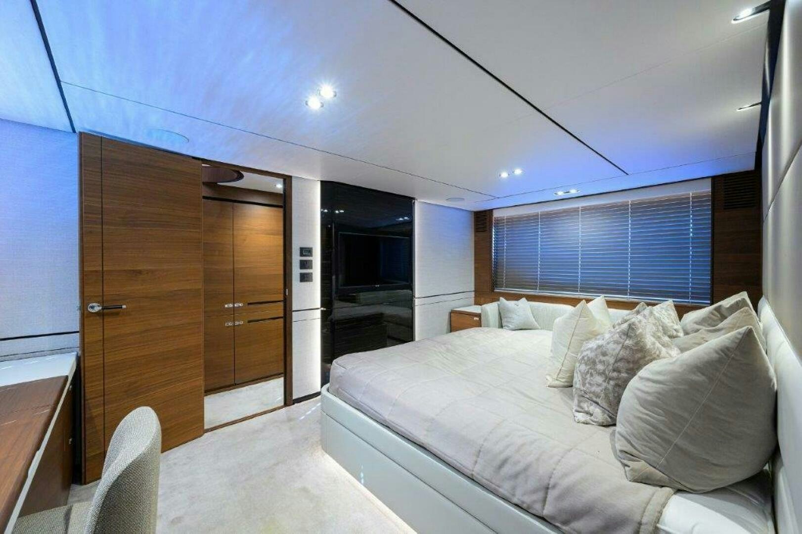 a bedroom with a bed and a closet aboard TARHEEL Yacht for Sale