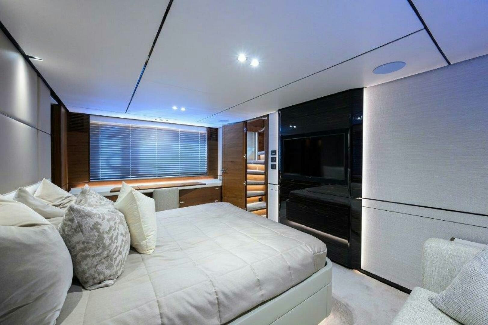 a bedroom with a bed and a large closet aboard TARHEEL Yacht for Sale