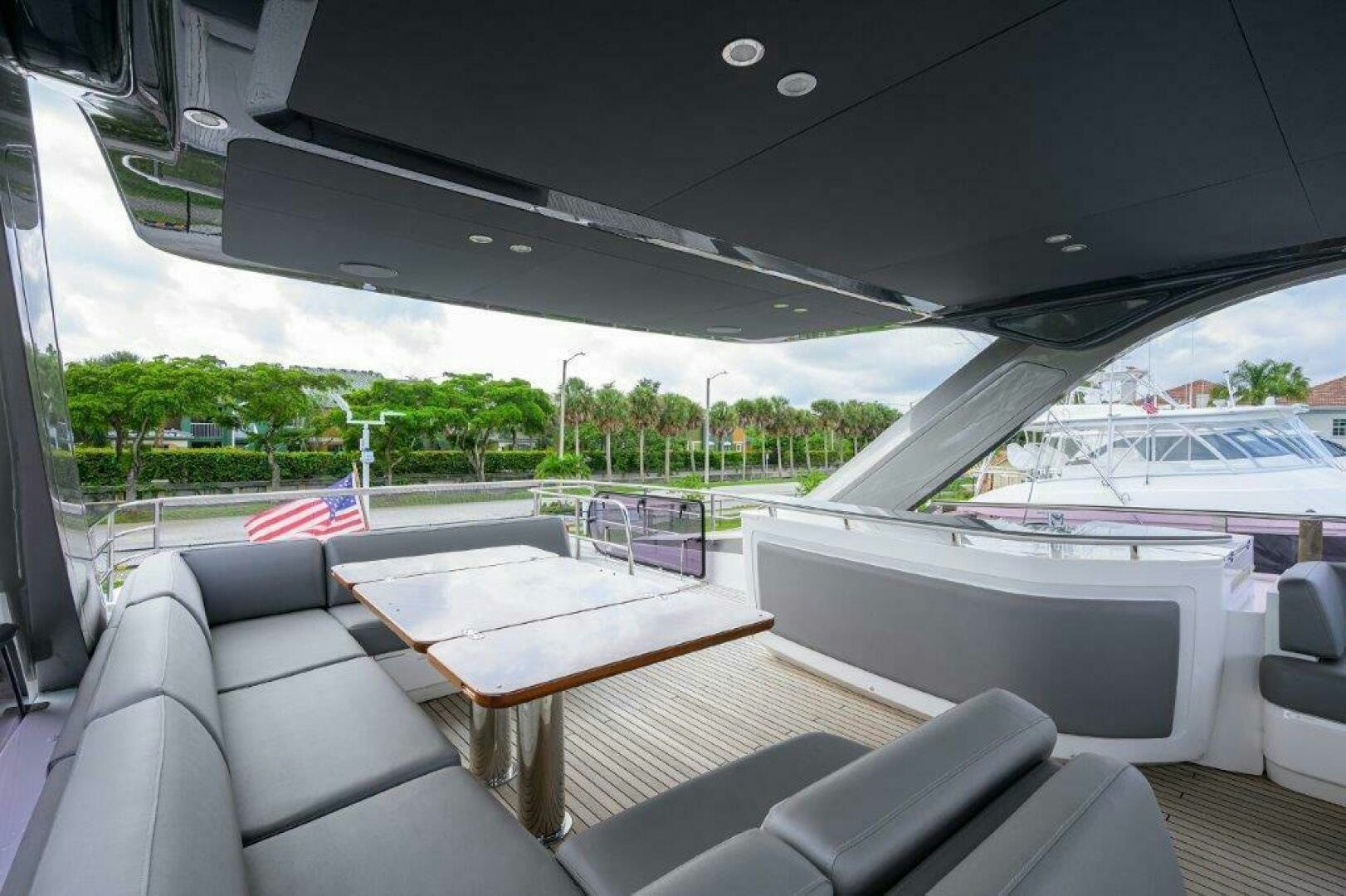 a deck with a table and chairs aboard TARHEEL Yacht for Sale