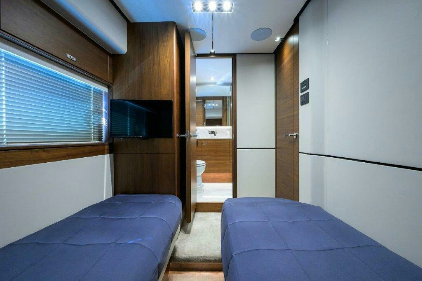 a room with a bed and a closet aboard TARHEEL Yacht for Sale