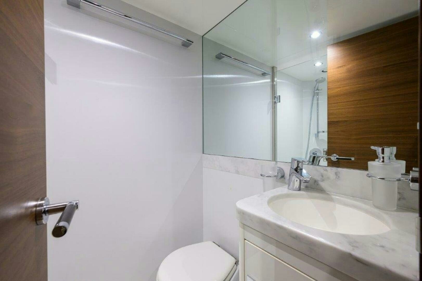 a bathroom with a toilet and a sink aboard TARHEEL Yacht for Sale