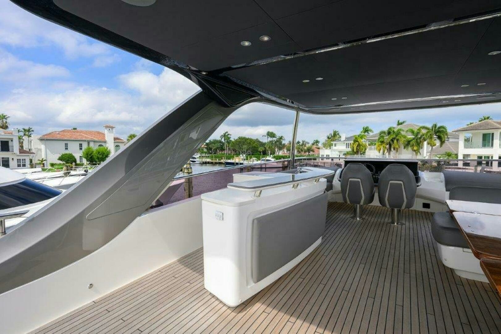a deck with chairs and a table aboard TARHEEL Yacht for Sale
