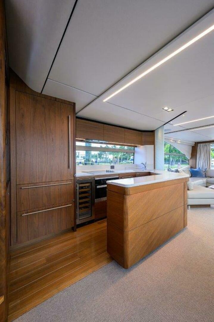 a kitchen with wooden cabinets aboard TARHEEL Yacht for Sale