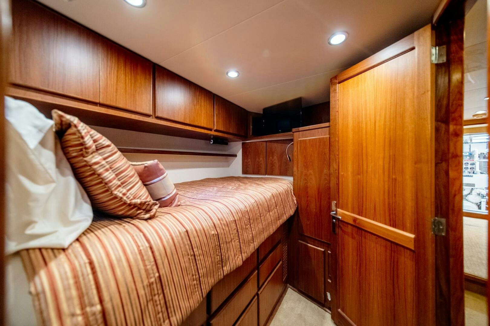 a bedroom with wooden cabinets aboard SEA LION Yacht for Sale