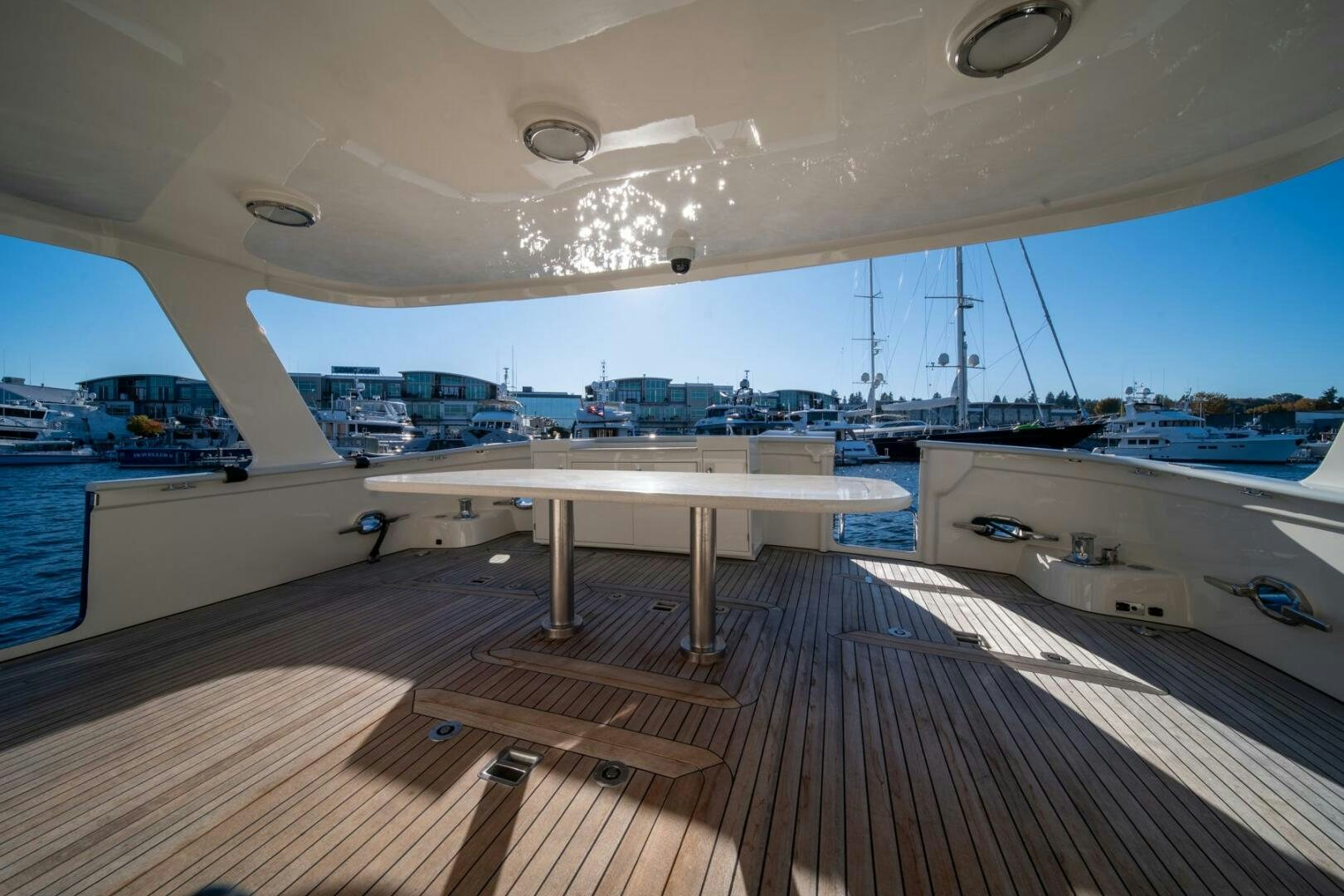 a deck with a view of the water and boats aboard SEA LION Yacht for Sale