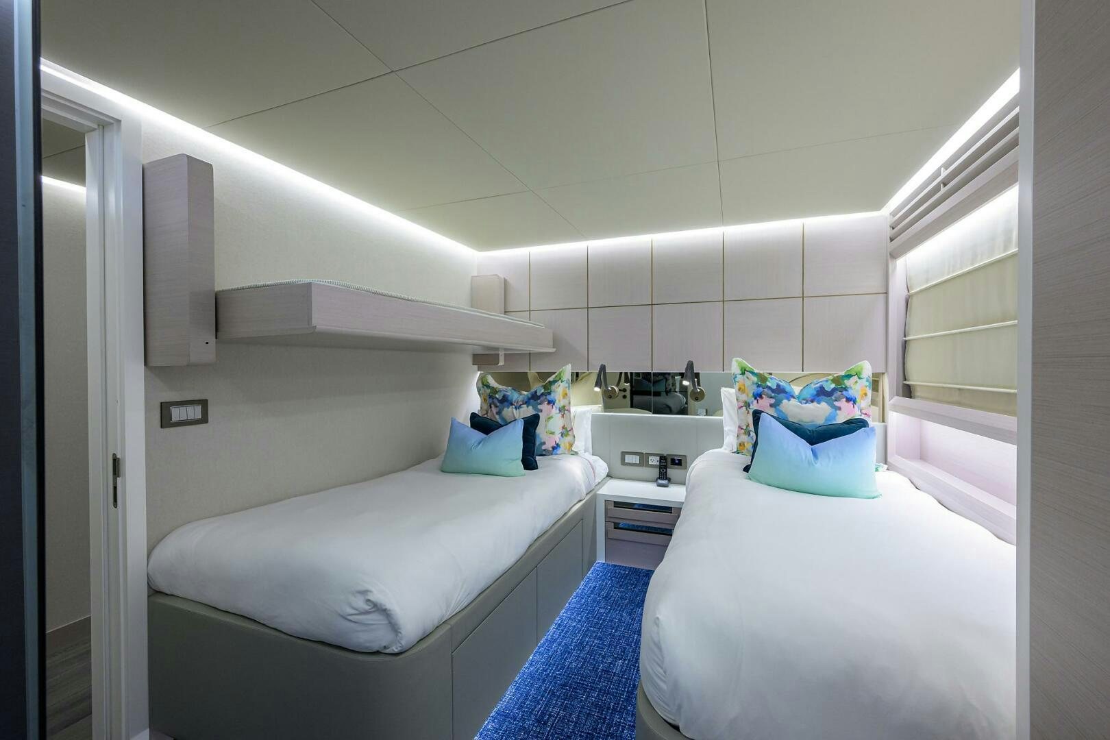 a room with two beds aboard AMORE Yacht for Sale