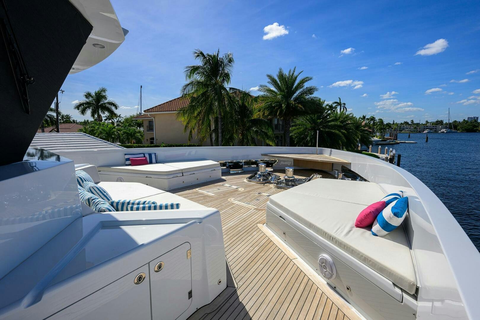 a deck with a pool and a couple of boats on it aboard AMORE Yacht for Sale