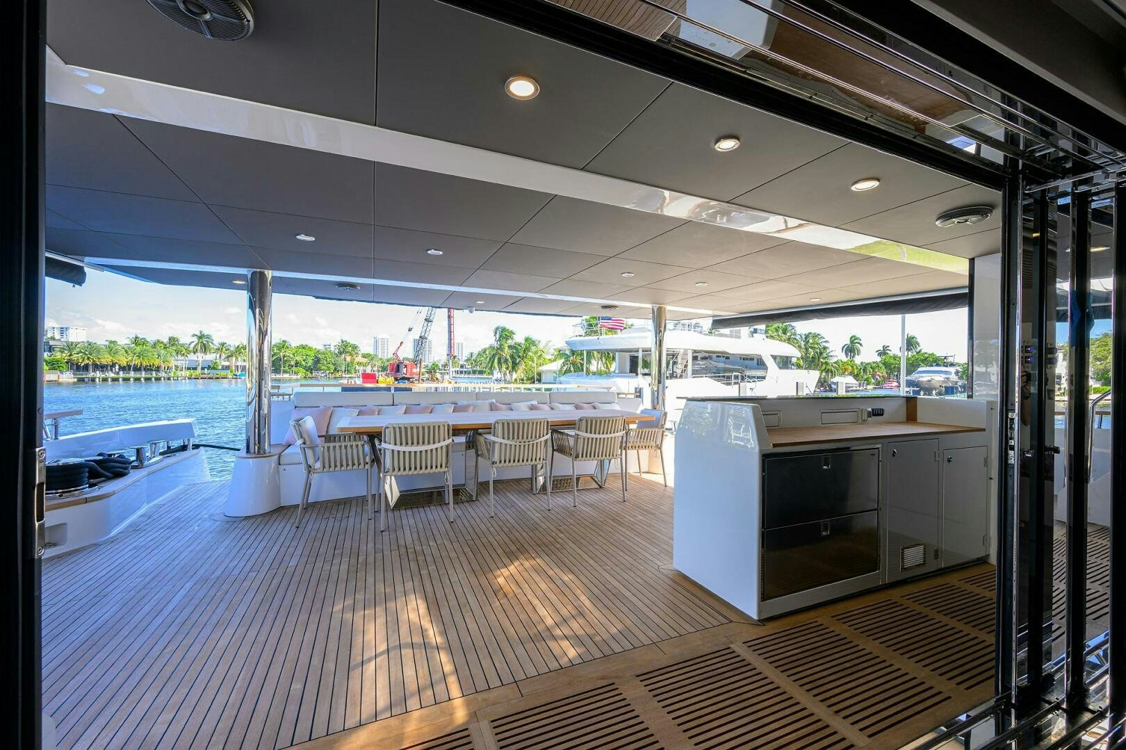 a room with tables and chairs aboard AMORE Yacht for Sale