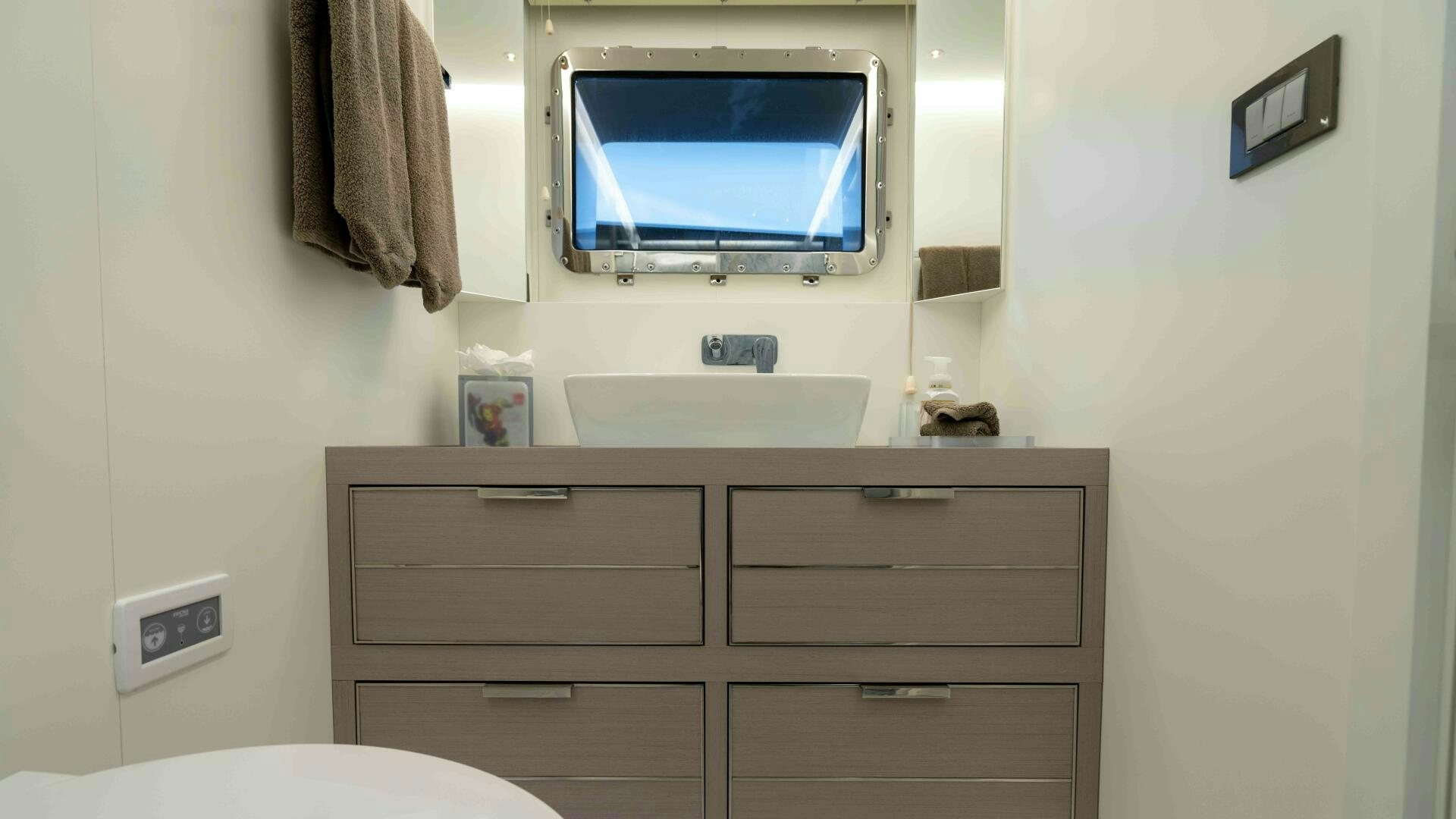 a television on a dresser aboard AMORE Yacht for Sale