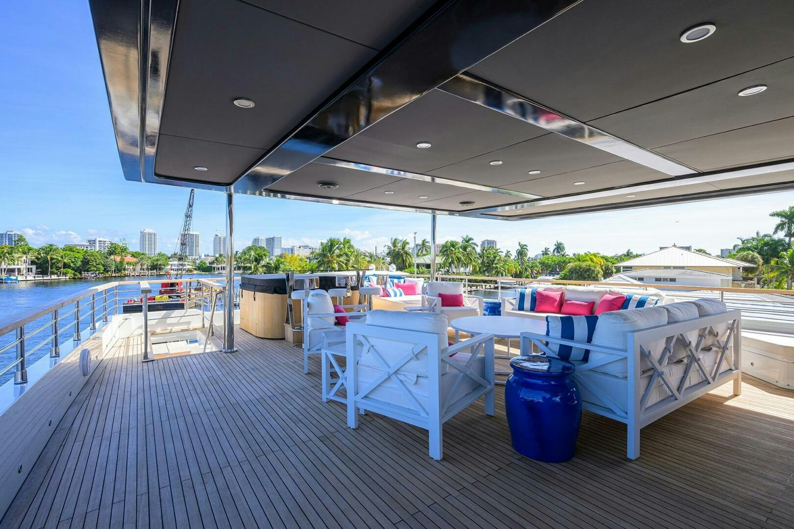 a deck with tables and chairs aboard AMORE Yacht for Sale