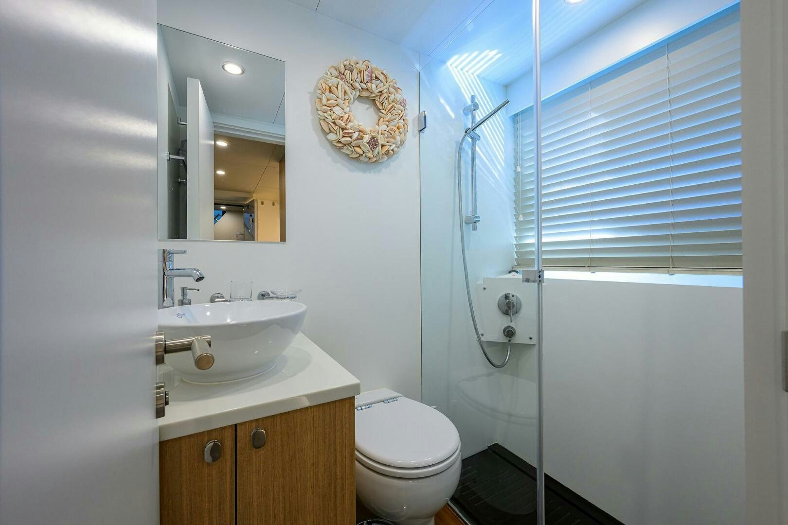a bathroom with a sink toilet and a shower unit aboard AMORE Yacht for Sale