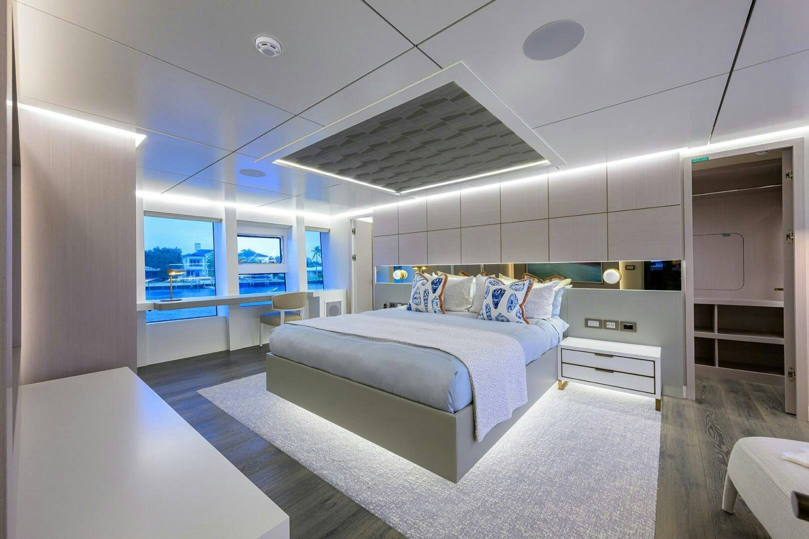 a modern bedroom with a large bed aboard AMORE Yacht for Sale